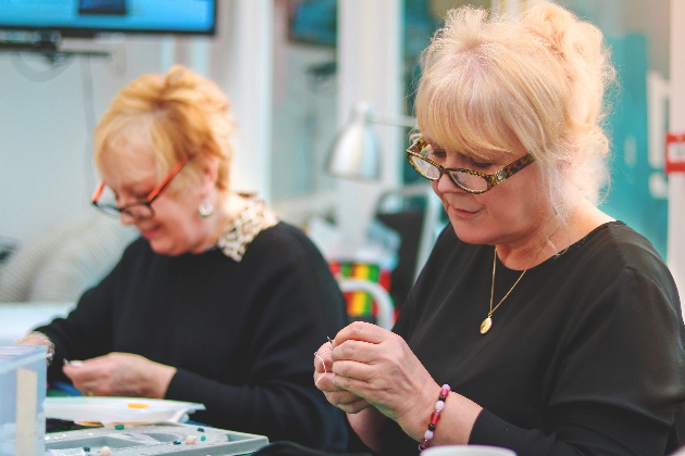 two ladies hand making jewellery