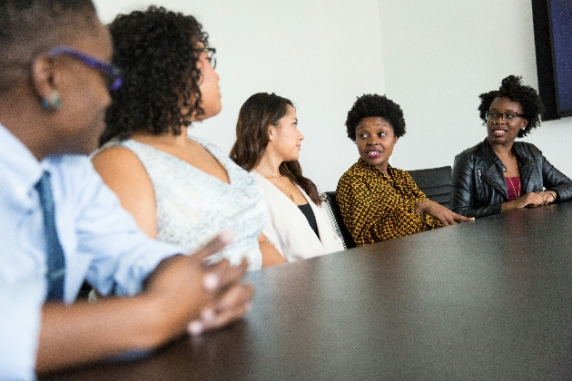 5 women talking with each other