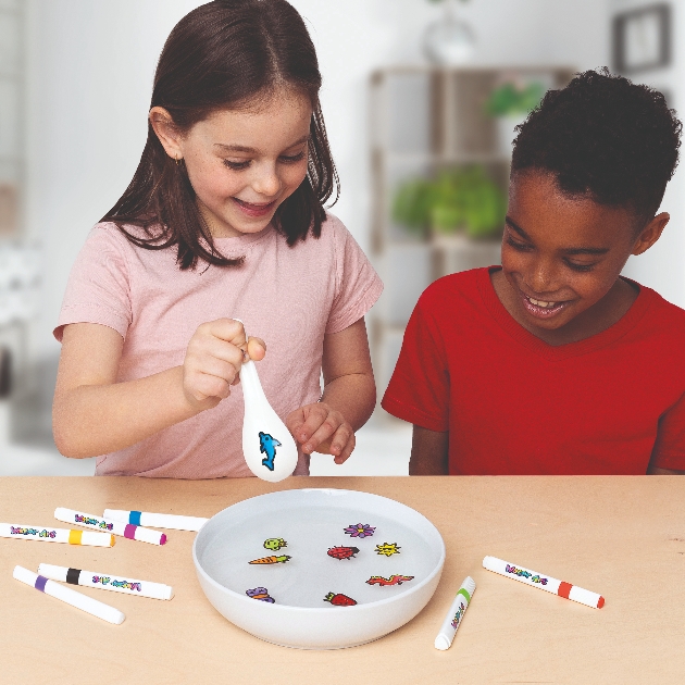 two children playing with water craft set