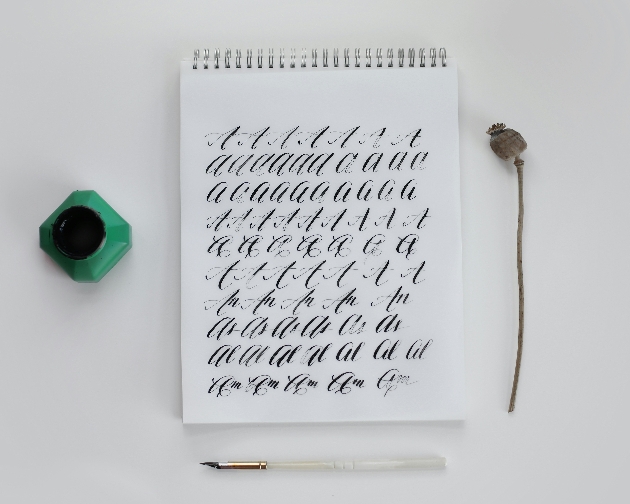 notepad with calligraphy letters