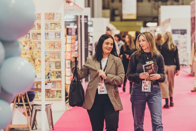 two ladies walking at a trade fair