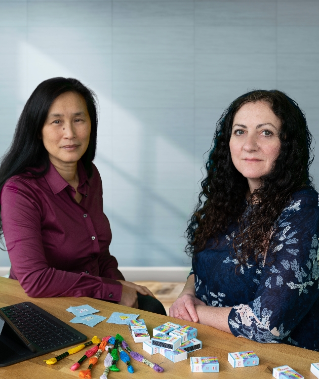 two brunette ladies with small craft kits