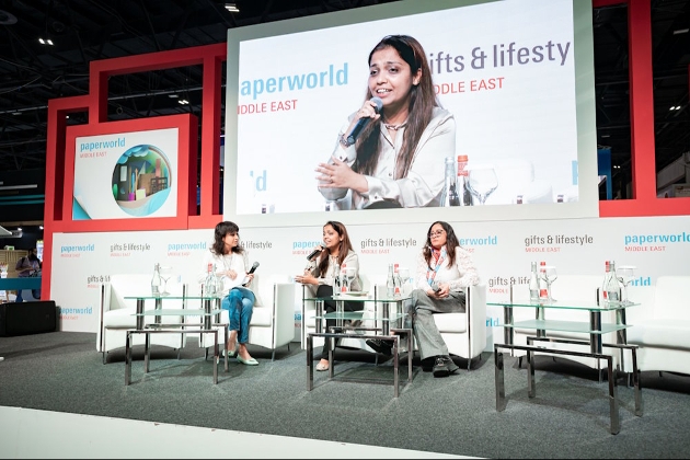 three women on discussion panel on stage