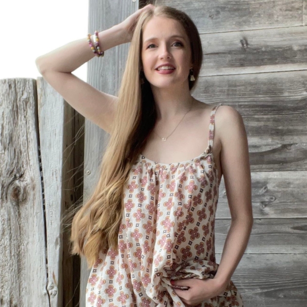 young lady with long light brown hair in floral dress